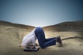 The businessman hiding his head in sand escaping from problems Royalty Free Stock Photo