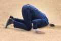 The businessman hiding his head in sand escaping from problems Royalty Free Stock Photo