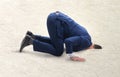 Businessman hiding his head in sand escaping from problems