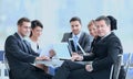 Businessman and his business team with financial documents sitting at a Desk in the lobby of the Bank. Royalty Free Stock Photo