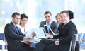 Businessman and his business team with financial documents sitting at a Desk in the lobby of the Bank. Royalty Free Stock Photo