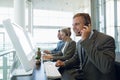Businessman with his colleagues talking on headset at desk Royalty Free Stock Photo