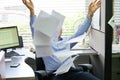 Businessman at his desk throws documents and papers into the air Royalty Free Stock Photo