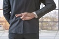 Businessman with his fingers crossed behind his back in the office Royalty Free Stock Photo