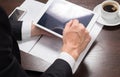 Businessman at his workplace with a Cup of coffee and tablet computer. Close-up Royalty Free Stock Photo