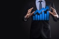 Businessman hold drawing on screen growing graph  arrow of positive growth icon.pointing at creative business chart with upward Royalty Free Stock Photo