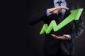 Businessman hold drawing on screen growing graph  arrow of positive growth icon.pointing at creative business chart with upward Royalty Free Stock Photo