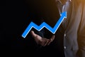 Businessman hold drawing on screen growing graph  arrow of positive growth icon.pointing at creative business chart with upward Royalty Free Stock Photo