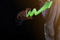 Businessman hold drawing on screen growing graph  arrow of positive growth icon.pointing at creative business chart with upward Royalty Free Stock Photo