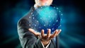 Businessman hold a holographic globe over his hand