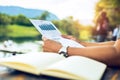 Businessman hold paper graph chart on the table near the river. Working at vocation