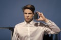 Businessman hold perfume in wardrobe on blue background