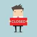 Businessman hold a sign Closed in his hands. Vector