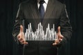 Businessman holding abstract business graph