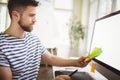 Businessman holding adhesive notes in creative office