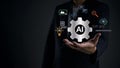 Businessman holding AI gear symbol in hand innovation digital technology, artificial intelligence, smart data analysis, future Royalty Free Stock Photo