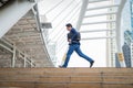 Businessman holding bag and running rapidly in the city. concept of rush hour and late for work.