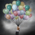 Businessman holding balloons
