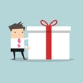 Businessman holding a big gift box for Christmas festival Royalty Free Stock Photo