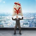 Businessman holding big moneybag with yen sign