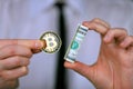 Businessman holding bitcoin and bundle of dollars in his hands