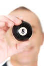 Businessman holding black billiard ball Royalty Free Stock Photo