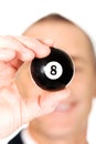 Businessman holding black billiard ball Royalty Free Stock Photo