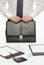 Businessman holding a black briefcase and standing near the work Royalty Free Stock Photo