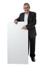 Businessman holding a blank sign Royalty Free Stock Photo