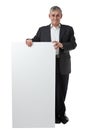 Businessman holding a blank sign Royalty Free Stock Photo