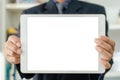 Businessman holding a blank white touch screen tablet. Used to put text or information to advertise news or sell products online. Royalty Free Stock Photo