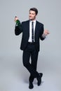 Businessman holding bottle with champagne and glass Royalty Free Stock Photo