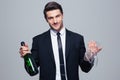 Businessman holding bottle with champagne and glass Royalty Free Stock Photo