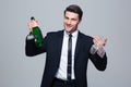 Businessman holding bottle with champagne and glass Royalty Free Stock Photo