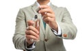 Businessman holding bottle of perfume on white background