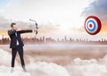 Businessman holding bow and arrow while aiming at the target board Royalty Free Stock Photo