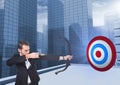 Businessman holding bow and arrow while aiming at the target board Royalty Free Stock Photo