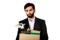 Businessman holding box with personal belongings.