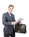 Businessman holding brief case and documents