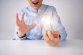 Businessman holding a bright light bulb. Concept of Ideas for presenting new ideas Great inspiration and innovation new beginning Royalty Free Stock Photo