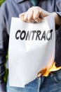 Businessman is holding a burning contract Royalty Free Stock Photo