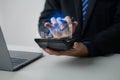 Businessman holding calculator with hologram graph showing financial data for calculation, he is analyzing historical financial