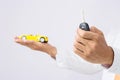 Businessman holding a car keys and miniature car model, Auto business and financial concept