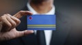 Businessman Holding Card of Aruba Flag