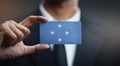 Businessman Holding Card of Federated States of Micronesia Flag