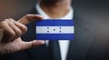 Businessman Holding Card of Honduras Flag