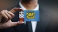 Businessman Holding Card of Saint Pierre and Miquelon Flag