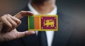 Businessman Holding Card of Sri Lanka Flag