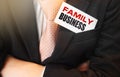 Businessman holding a card with text Family Business. Business concept Royalty Free Stock Photo