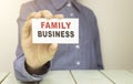 Businessman holding a card with text Family Royalty Free Stock Photo